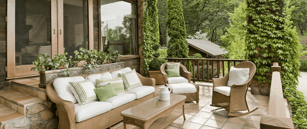 matching patio furniture on front deck of home