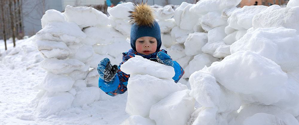 child building snow fort